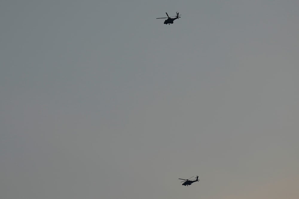 Israeli Apache helicopters fly toward northern occupied Palestine, Sunday, August 25, 2024 (AP)