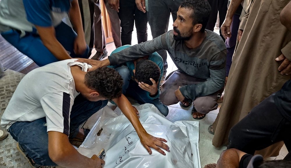 Palestinians mourn a relative killed in the Israeli bombardment of the Gaza Strip, at a hospital in Khan Younis, Saturday, Aug. 24, 2024. (AP)