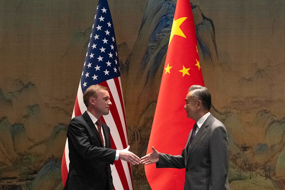 Wang Yi shakes hands with Jake Sullivan before their talk at Yanqi lake in Beijing, Tuesday, Aug. 27, 2024. (AP)