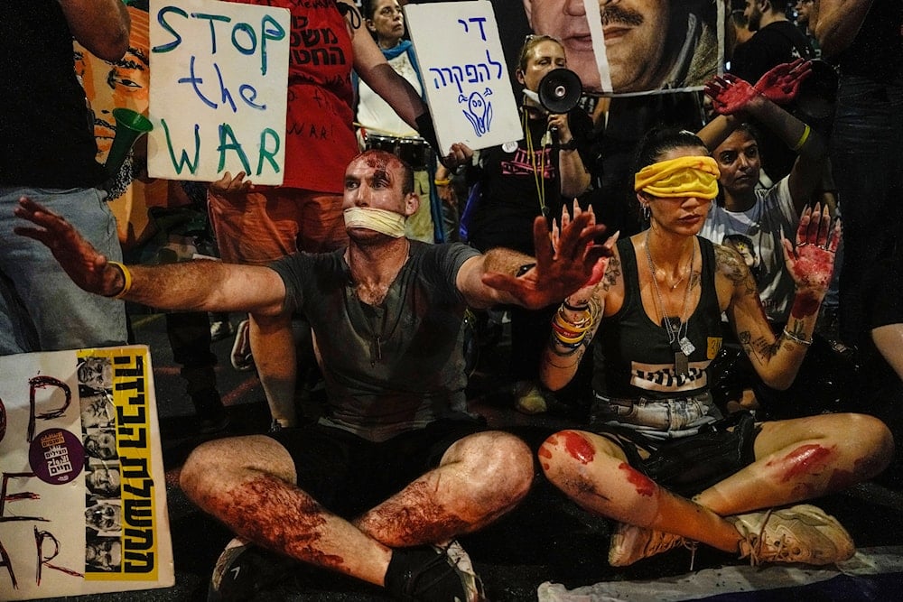 Relatives of Israeli captives and their supporters call for their immediate release and to protest against Israeli Prime Minister Benjamin Netanyahu's government in Tel Aviv, occupied Palestine, Saturday, Aug. 17, 2024. (AP)