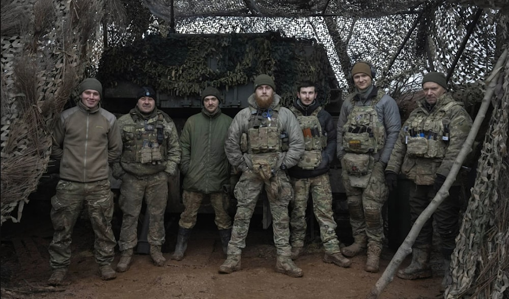 Soldiers of the 12th Special Forces Brigade Azov of the National Guard pose at the 155mm self-propelled gun M109 Paladin at the front line, near the Kreminna, Luhansk region, Ukraine on January 28, 2024. (AP)