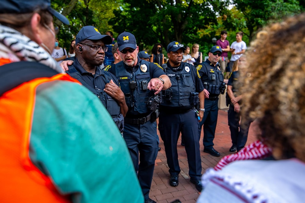 An image showing US police officers on the campus of the University of Michigan just before arresting a pro-Palestine protestor on August 28, 2024. (Social media)