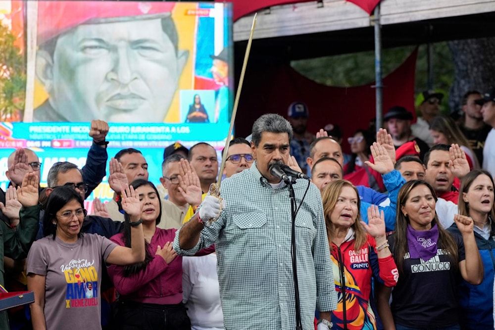 Venezuela's President Nicolás Maduro brandishes a sword as his new Cabinet takes the oath of office, at the presidential palace in Caracas, Venezuela, Wednesday, Aug. 28, 2024. (AP)