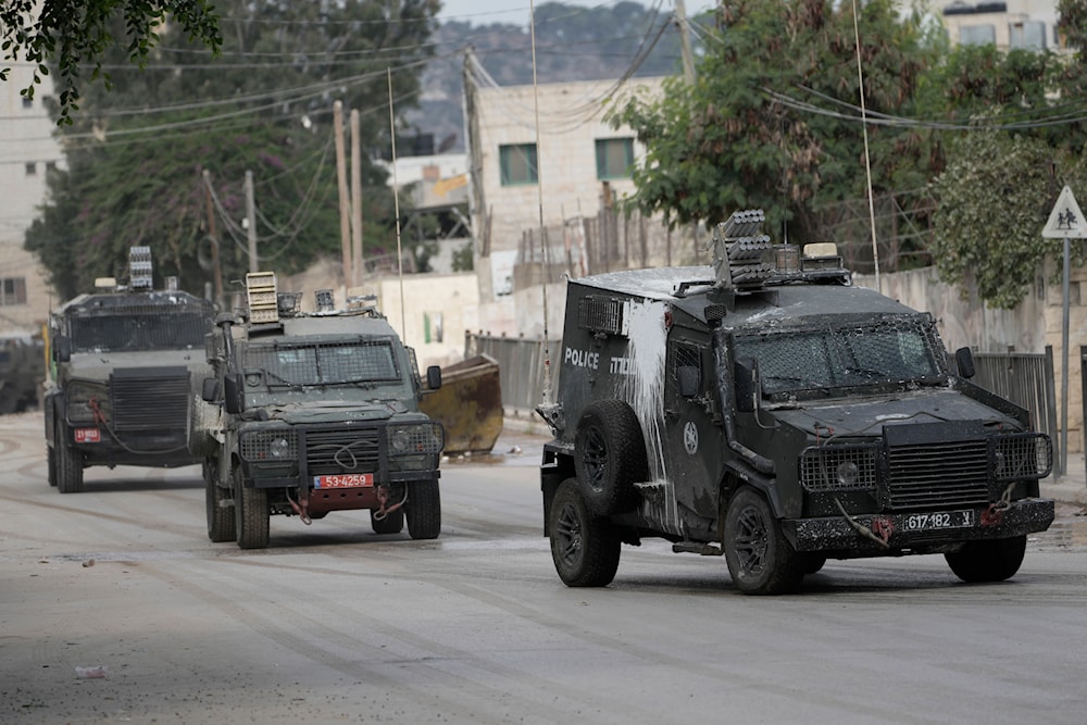 Israeli armoured vehicles move on a street during a military operation in the West Bank city of Jenin, on August 28, 2024.  (AP)