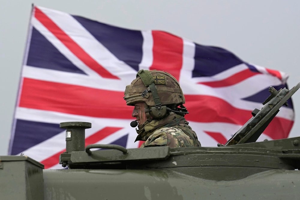 A British soldier sits in an AS90 as take part in a military exercise with Ukrainian soldiers at a military training camp in an undisclosed location in England, Friday, March 24, 2023. 