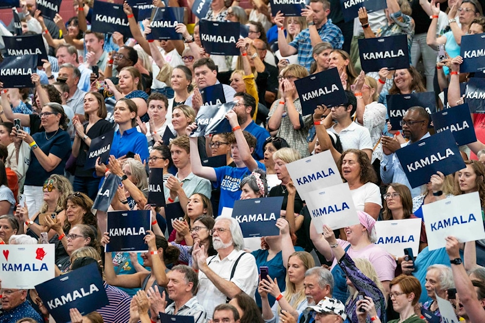 Supports hold up signs in support of Vice President Kamala Harris at an event, July 23, 2024, in West Allis, Wis. (AP Photo/Kayla Wolf, File)