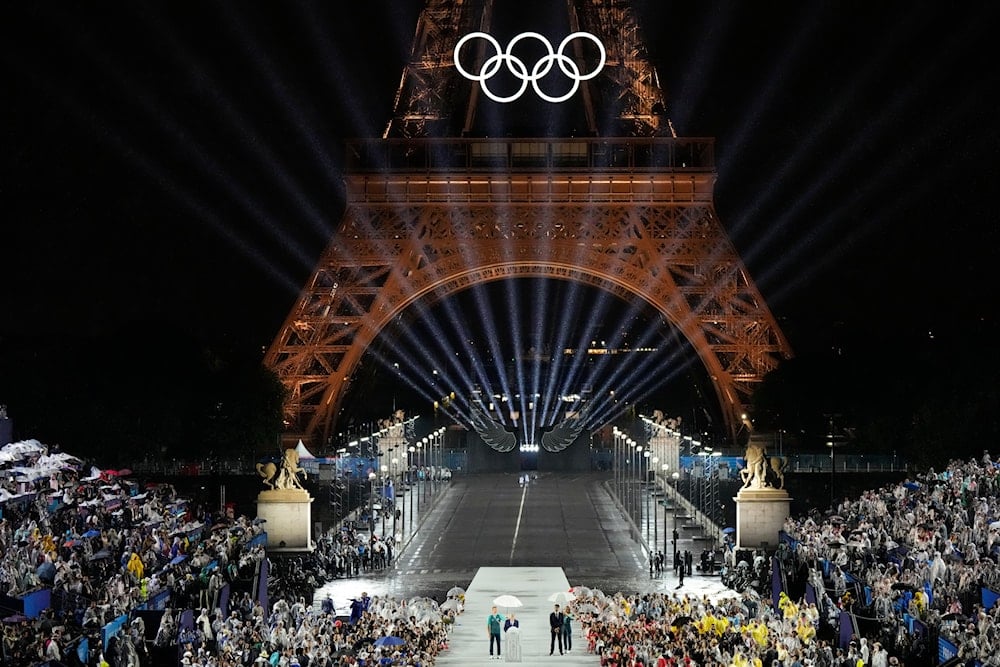 IOC President Thomas Bach speaks as Tony Estanguet, president of 2024 Paris Olympics looks on in Paris, France, during the opening ceremony of the 2024 Summer Olympics, Friday, July 26, 2024 (AP)