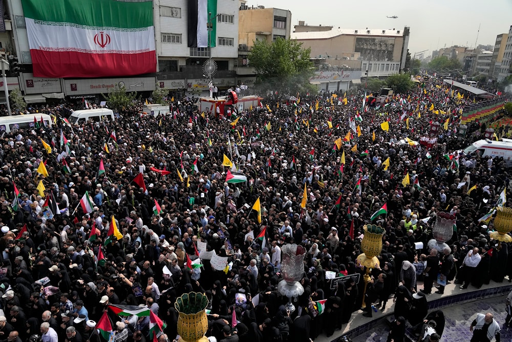 Iranians attend the funeral ceremony of Hamas leader Ismail Haniyeh and his bodyguard, at Enqelab-e-Eslami (Islamic Revolution) Sq. in Tehran, Iran, Thursday, August 1, 2024 (AP)