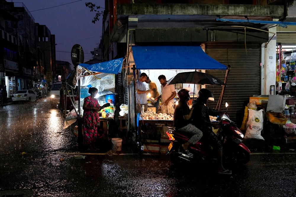  Roadside vendors wait for customers at a market place in Colombo, Sri Lanka, Friday, Dec. 8, 2023. (AP)