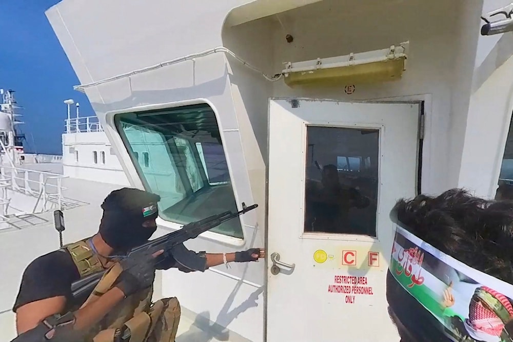 This photo released by the Houthi Media Center shows Ansar Allah forces boarding the cargo ship Galaxy Leader on Sunday, Nov. 19, 2023. (AP)