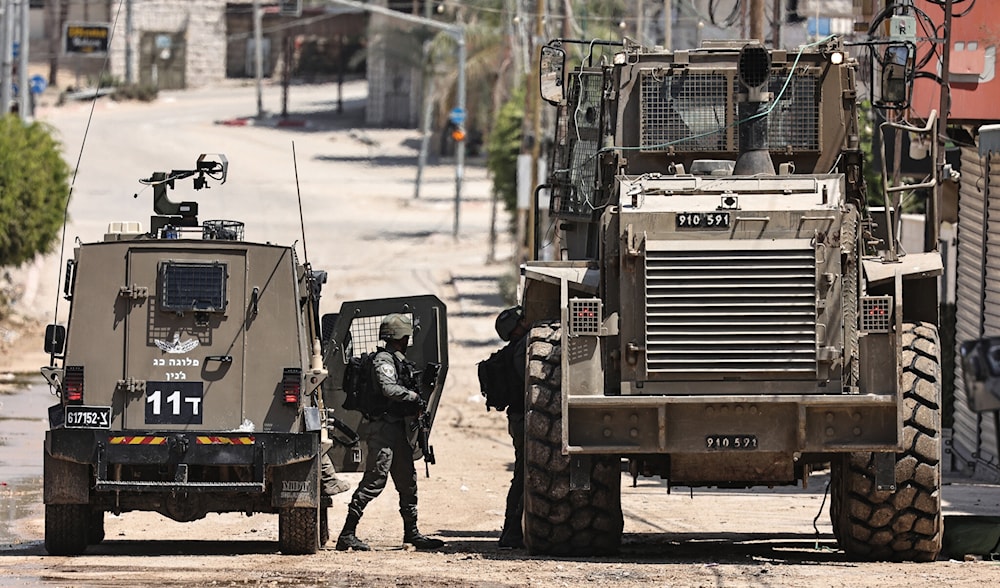 Israeli Occupation Forces (IOF) soldiers and military vehicles deployed in Nur Shams camp near Tulkarem on August 22, 2024. (AFP)