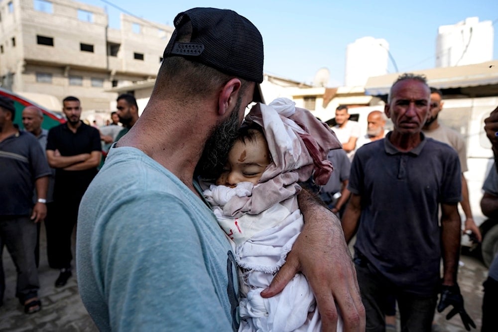 Relatives mourn a child killed in the Israeli bombardment of the Gaza Strip at a hospital in Deir al-Balah, Friday, Aug. 30, 2024 (AP Photo/Abdel Kareem Hana)