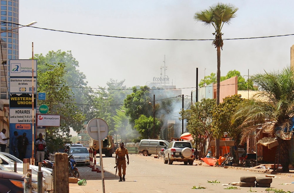 A soldier walks near the rear of the Army Headquarters in central Ouagadougou, Burkina Faso, Friday March 2, 2018. (AP)