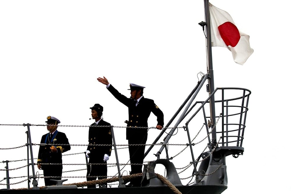 An officer signals as the Japanese destroyer Suzutsuki docks at a port in Qingdao in eastern China's Shandong Province, Sunday, April 21, 2019. (AP)