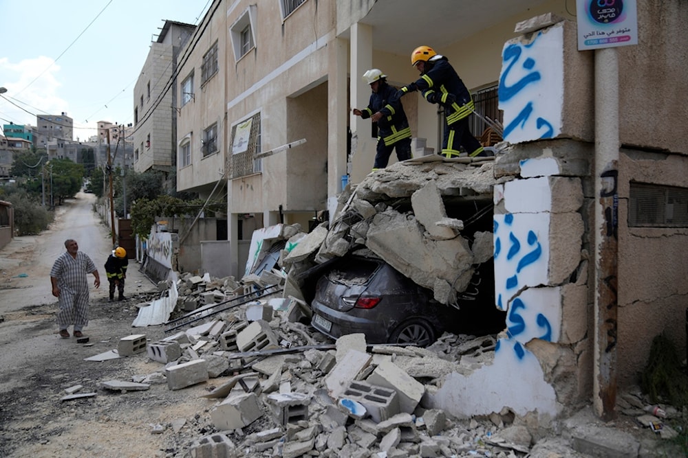 Palestinian civil defense workers clear the rubble from a damaged house following an Israeli military operation in the West Bank refugee camp of Nur Shams, Tulkarm, August 30, 2024 (AP)