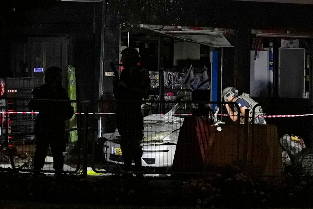 Israeli security forces examine a car after an explosion at a gas station in the West Bank settlement of Gush Etzion, Saturday, Aug. 31, 2024. (AP)