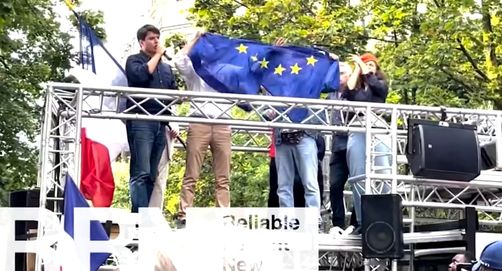 Protestors rip off EU flag at a demonstration in Paris. Demonstrators gathered in Paris on August 31, 2024, to call for French President Emmanuel Macron's 