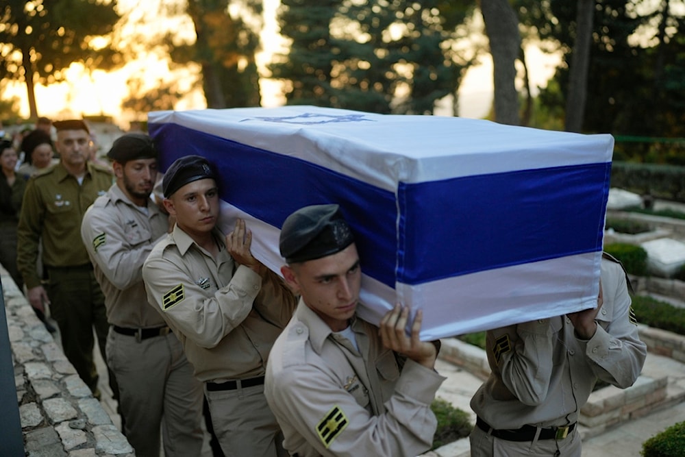 Israeli occupation soldiers carry the flag-draped coffin of Petty Officer 1st Class David Moshe Ben Shitrit, who was killed in a Hezbollah operation, during his funeral in occupied al-Quds, Sunday, Aug. 25, 2024. (AP)