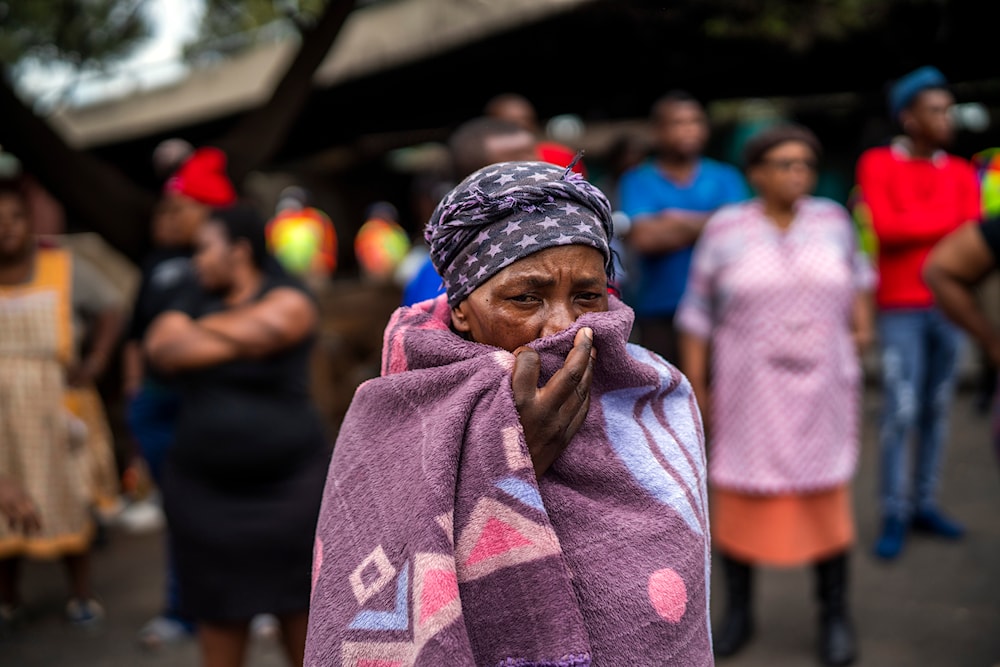 People living near the traditional medicine market wait to receive food baskets from private donors, Monday, April 13, 2020 downtown Johannesburg. (AP)