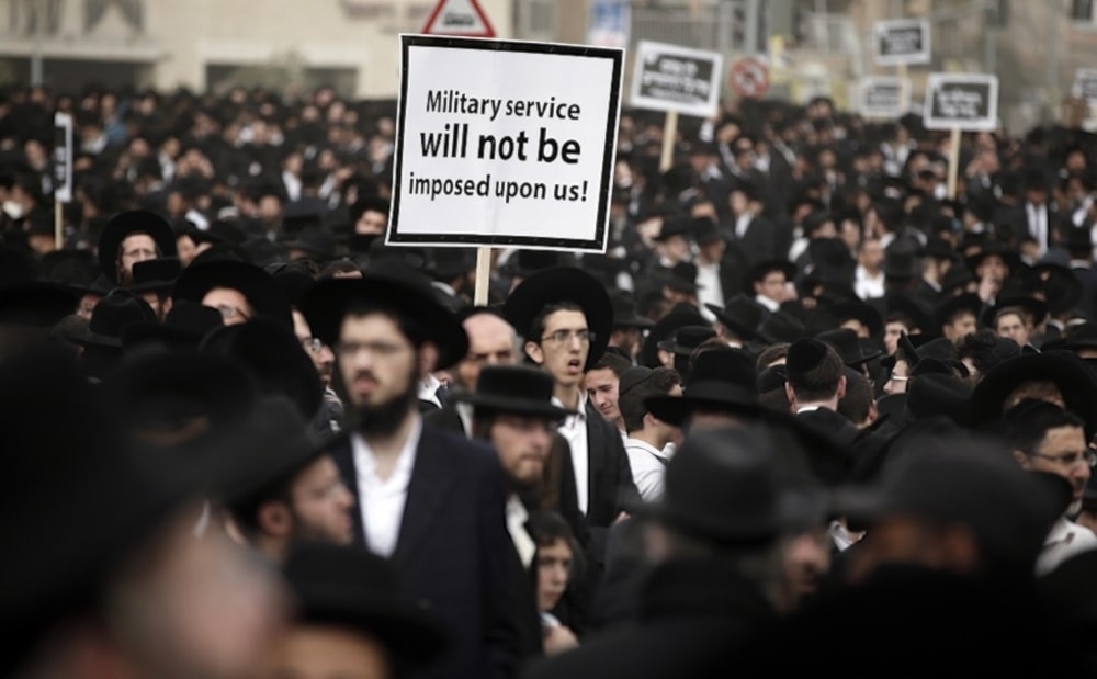 Hundreds of ultra-Orthodox Israelis protesting against plans to make them undergo military service in occupied al-Quds on March 2,2024. (AFP)