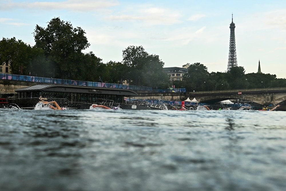 Athletes compete in the swimming race in the Seine River during the women's individual triathlon at the 2024 Summer Olympics, Wednesday, July 31, 2024, in Paris, France (Pool/AP)