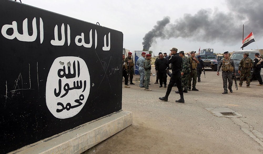 Bullet holes on an ISIS mural, undated. (AFP)