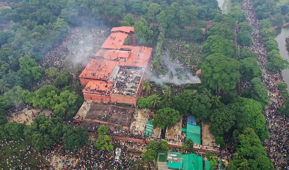 An aerial view shows anti-government protestors storming Bangladesh’s ousted Prime Minister Sheikh Hasina’s palace in Dhaka on August 5, 2024. (AFP)