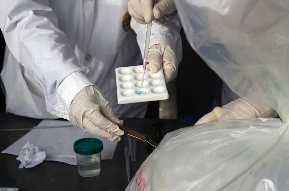 Laboratory scientists at work in Lima, Peru, Tuesday, Oct. 11, 2016. (AP)