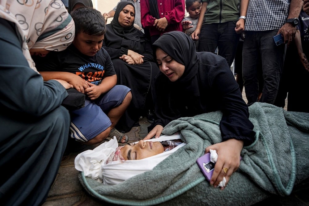 Palestinians mourn for a relative killed in the Israeli bombardment of the Gaza Strip, at a hospital in Deir al-Balah, Sunday, Aug. 4, 2024. (AP)