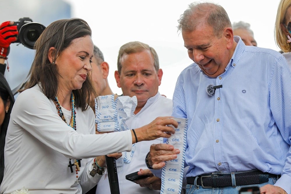 Opposition leader Maria Corina Machado, left, and opposition candidate Edmundo Gonzalez hold up vote tally sheets during a protest against the official presidential election results, Venezuela, July 30, 2024. (AP)