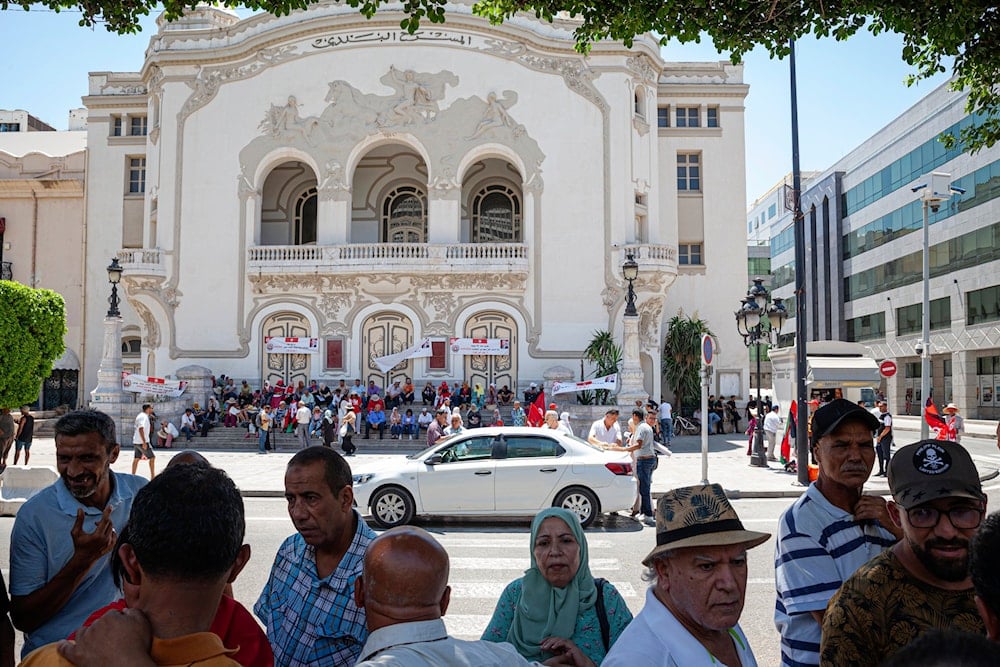 A supporter of Tunisian President Kais Saied speaks about the current situation in their country opposite the Municipal Theatre at Habib Bourguiba Avenue in Tunis, Thursday, July 25, 2024 (AP)