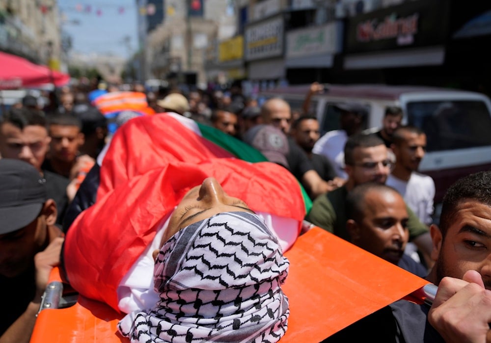 Mourners carry the body of Palestinian Yazan Abdo, 30 during his funeral in the occupied West Bank refugee camp of Tulkarm, July 24, 2024 (AP)