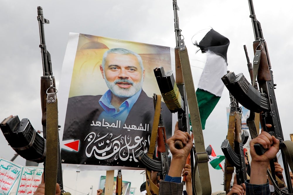 Yemeni protesters raise their machine guns during a protest to condemn the killing of Hamas leader Ismail Haniyeh, in Sanaa, Yemen, August 2, 2024 (AP)