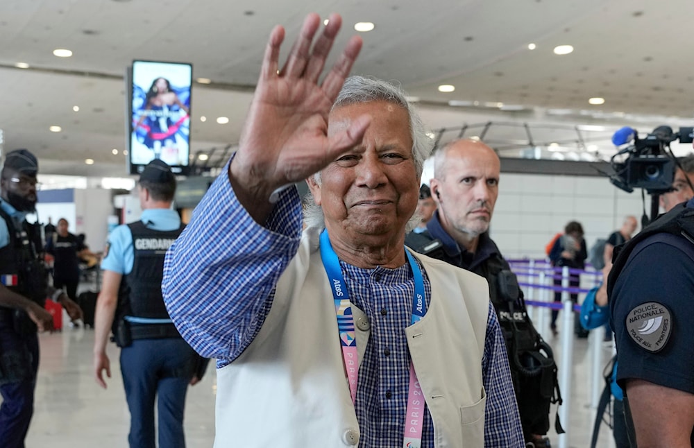 Nobel laureate Muhammad Yunus waves goodbye to the media at Charles de Gaulle's airport in Roissy, north of Paris, Wednesday, Aug. 7, 2024. (AP)