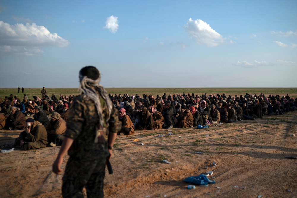 US-backed Syrian Democratic Forces (SDF) fighters stand guard next near Baghouz, eastern Syria, February 22, 2019 (AP)