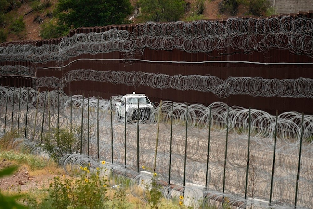 A vehicle drives along the U.S. side of the US-Mexico border wall in Nogales, Ariz. on Tuesday, June 25, 2024. (AP)