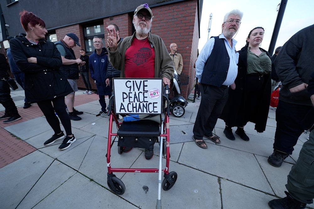 Counter protestors gather in Liverpool, UK, Wednesday, Aug. 7, 2024 ahead of anti-immigration groups planning to target dozens of locations throughout the country (AP)