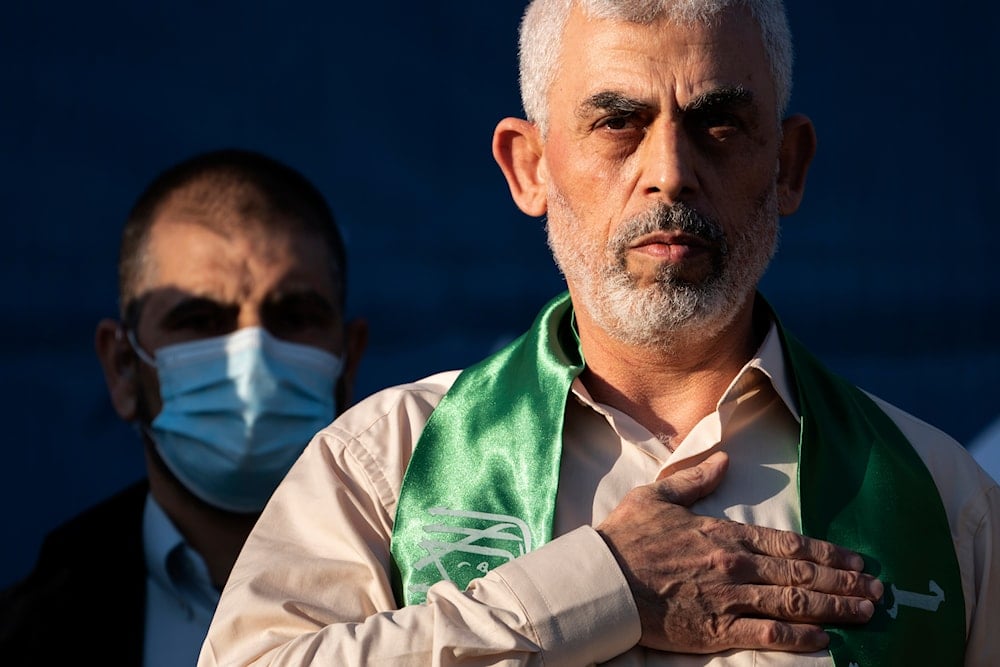 Yahya Sinwar, Palestinian leader of Hamas in the Gaza Strip, places his hand over his heart on stage after greeting supporters at a rally, Monday, May 24, 2021, in Gaza City, the Gaza Strip (AP)