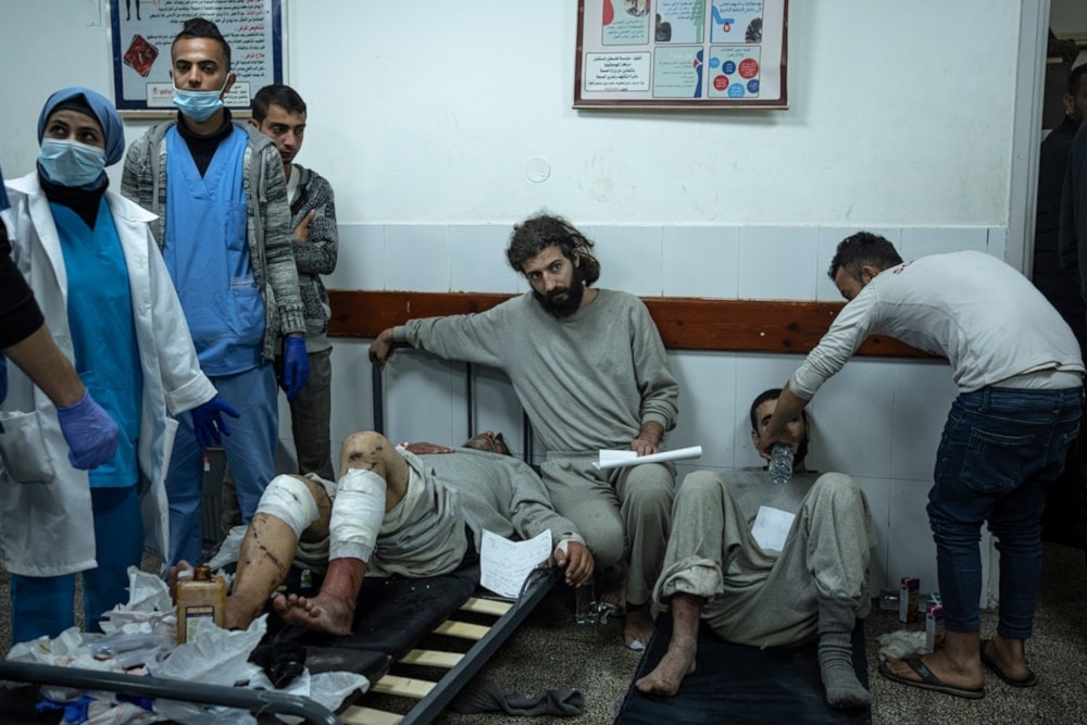 Palestinian detainees released by Israeli occupation forces through the Karam Abu Salem crossing wait to receive treatment after they were subjected to torture by Israeli occupation forces in Rafah, Gaza Strip, on December 23,2023. (AP)