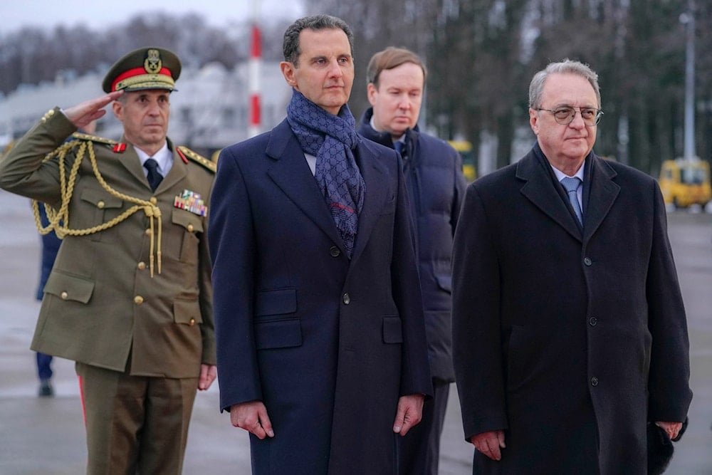 Syrian President Bashar Assad, left, and Mikhail Bogdanov, right, Deputy Minister of Foreign Affairs of Russia, review an honor guard during a welcome ceremony upon Assad's arrival at Vnukovo airport in Moscow, Russia, Tuesday, March 14, 2023 (SANA)