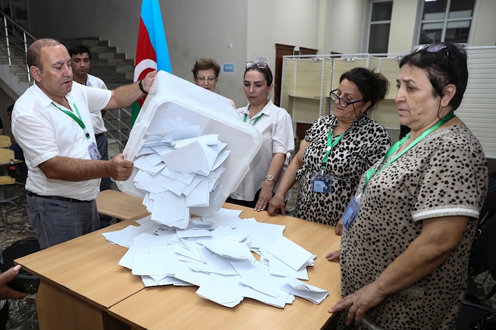 Members of an election commission prepare to count ballots at a polling station after a snap election in the Milli Mejlis parliament in Baku, Azerbaijan, Sunday, Sept. 1, 2024. (AP Photo)