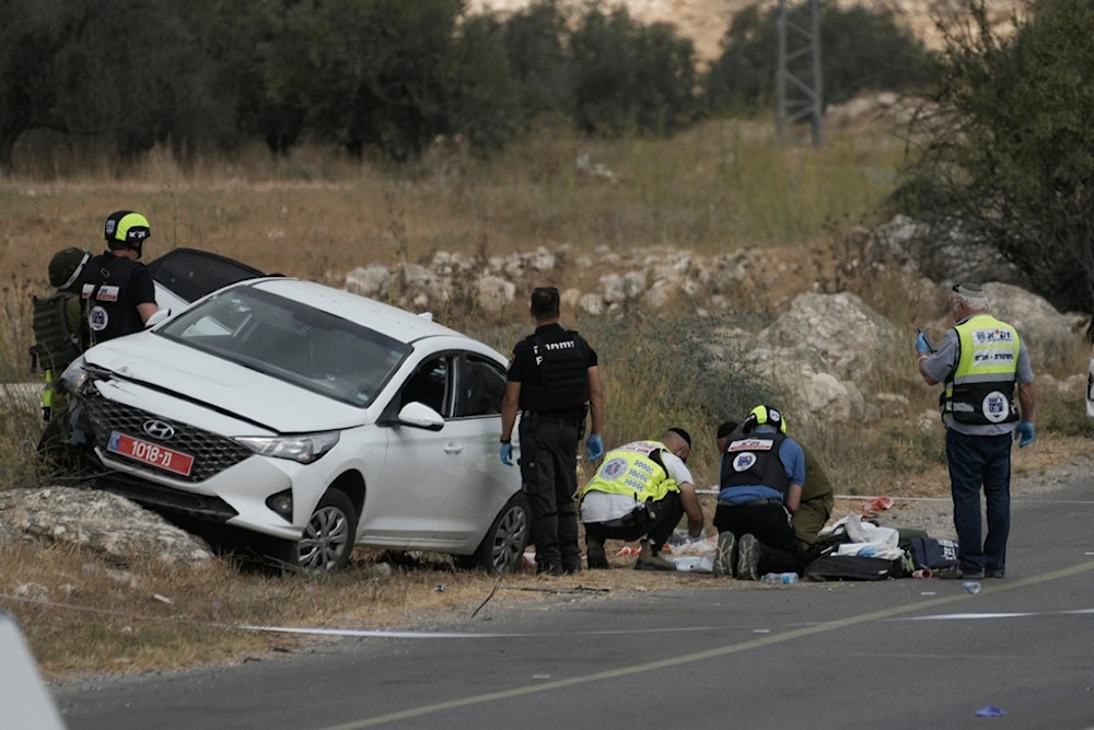 Israeli occupation forces and rescue services check the scene of a shooting operation in the West Bank city of Tarqumiyah, Sunday, Sept. 1, 2024. (AP)