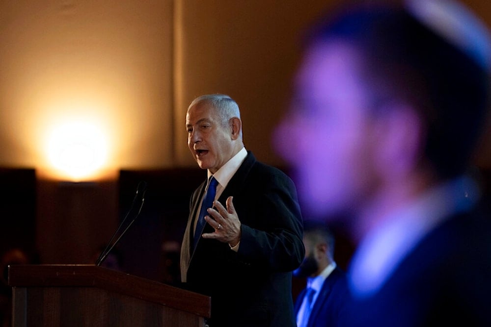 Israeli occupation Prime Minister Benjamin Netanyahu addresses the annual National Leadership Mission of the Conference of Presidents of Major American Jewish Organizations, in al-Quds, Palestine, Feb. 19, 2023. (AP)