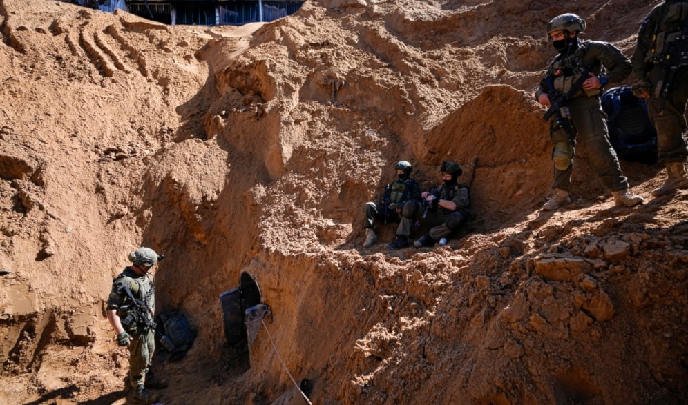 Israeli occupation soldiers guard a crater-like hole giving way to a small tunnel entrance in the Gaza Strip, Palestine, on Feb. 8, 2024. (AP)