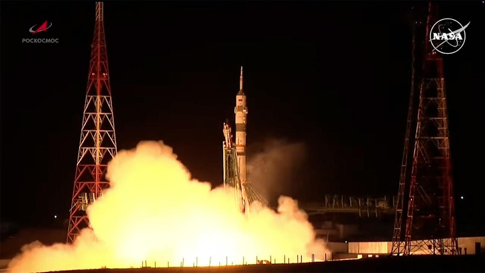 A Soyuz 2.1a rocket roars to life and climbs away from the Baikonur Cosmodrome in Kazakhstan carrying two veteran cosmonauts and a NASA astronaut on a flight to the International Space Station.