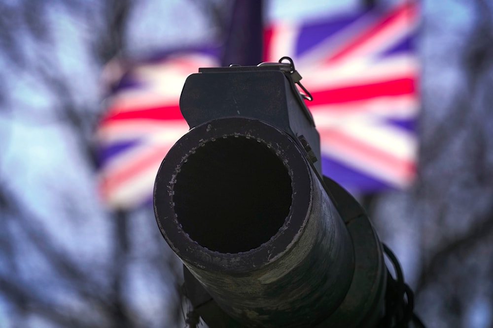 A cannon of a British Challenger 2 tank is backdropped by a UK flag during a celebration for Estonia's NATO membership 20th anniversary, in Tallinn, Estonia, Thursday, April 4, 2024. (AP)