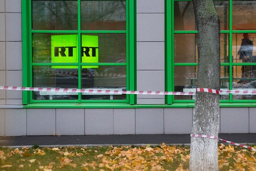 In this file photo taken dated Friday, Oct. 27, 2017, Russian state-owned television station RT logo is seen at the window of the company's office in Moscow, Russia. (AP)