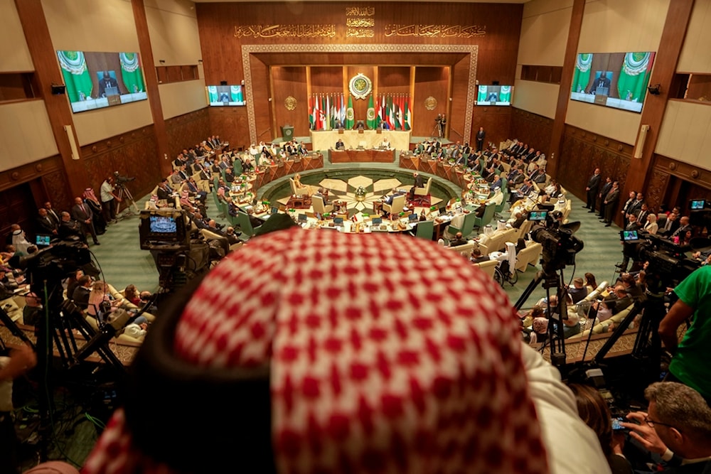 A photographer films the regular session of the Arab League, in Cairo, Egypt, Tuesday, September 10, 2024 (AP)