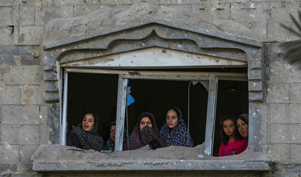 Palestinians look at the destruction after an Israeli occupation's airstrike on a crowded tent camp housing Palestinians displaced by the war in Mawasi, Gaza Strip, Tuesday, Sept. 10, 2024. (AP)