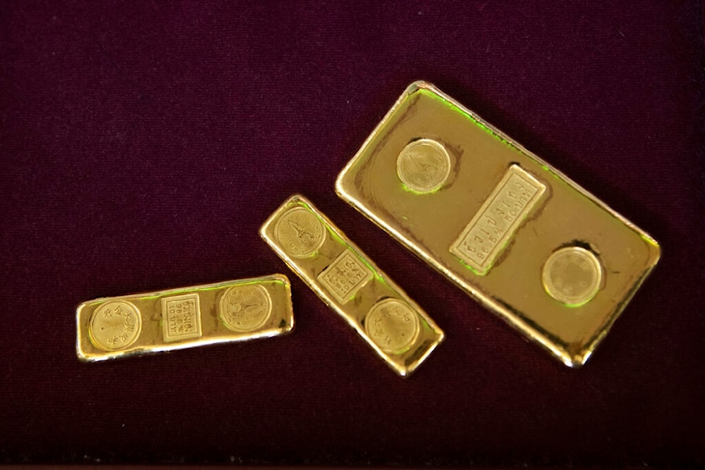  In this April 16, 2020, file photo, a customer puts gold bars on basket for sell to a gold shop in Bangkok, Thailand. (AP)